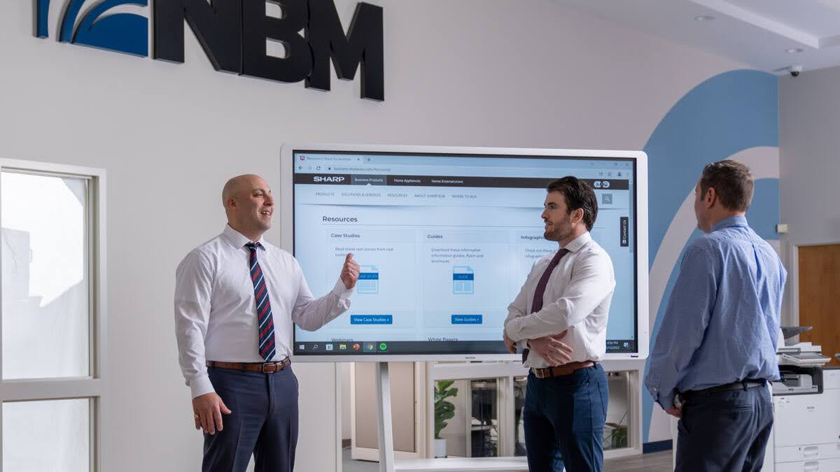 NBM sales executive helping clients understand the benefits of back scanning solutions. 