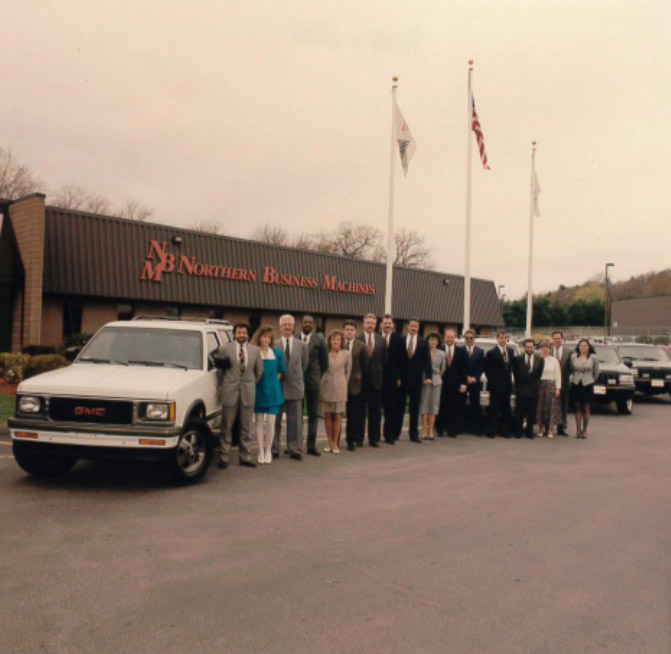 The NBM team celebrating its move into the new building in 1994