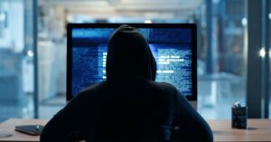 Cybercriminal hacking into a system 